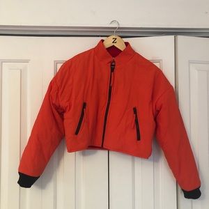 Orange Urban Outfitters puffer jacket